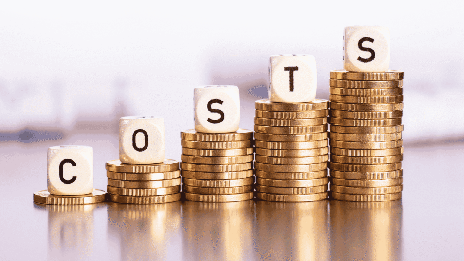 Coins stacked up in piles reading COSTS.